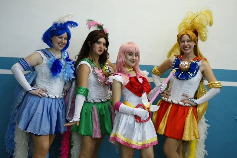 four women are posing in costume for a po