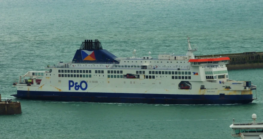 a large boat in the water near a dock