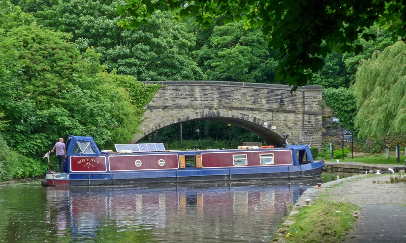 a boat in a body of water in front of a bridge