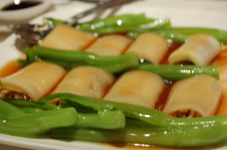 green peppers on a white plate with sauce