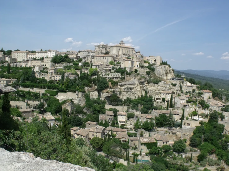 village perched over hills with trees on top of it