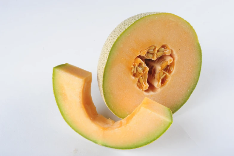 the top half of an open cantaloupe cut in half with a white background