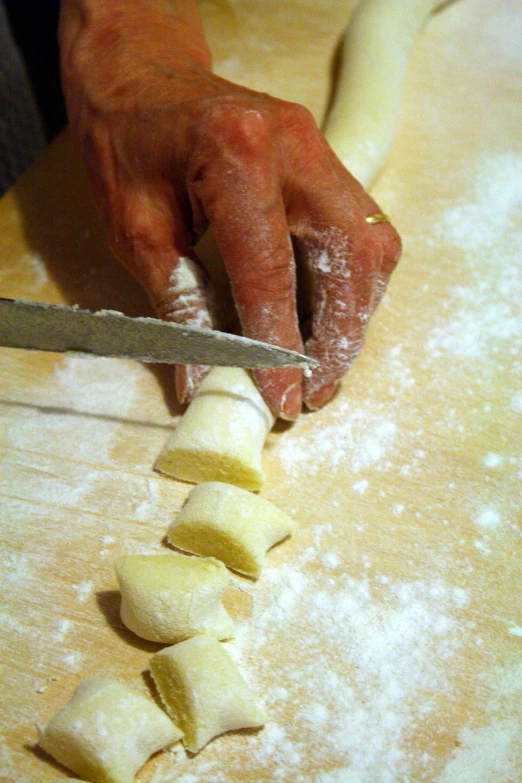 a man slicing potatoes on a  board