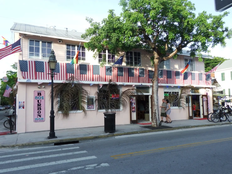 an old fashioned building with american flags on it