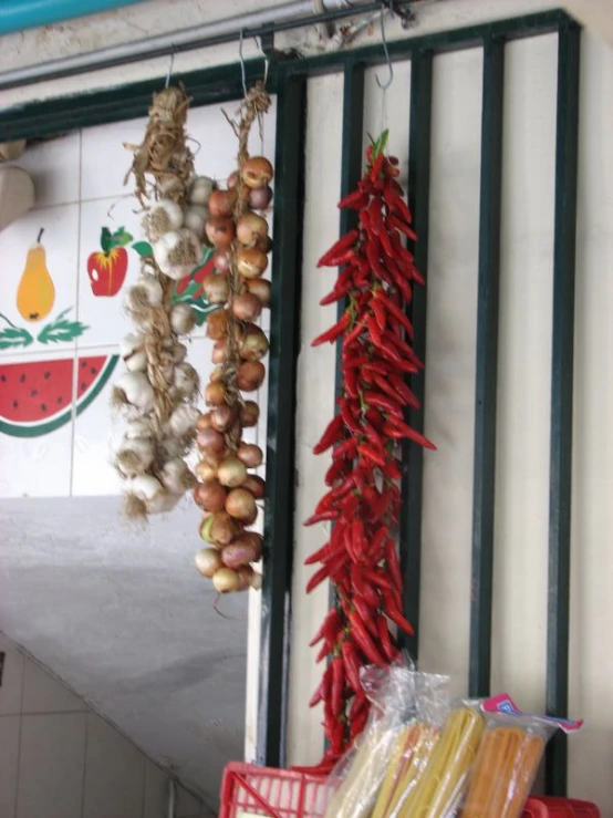 various spices and peppers hanging on rack in kitchen