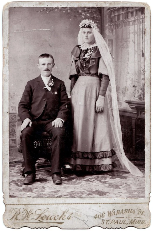 an old fashioned po with two people dressed in period clothing