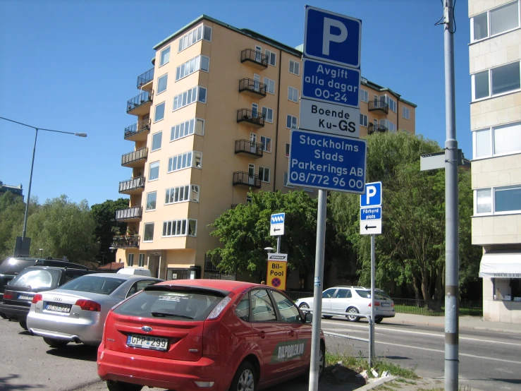 there are many signs in different languages on this street pole