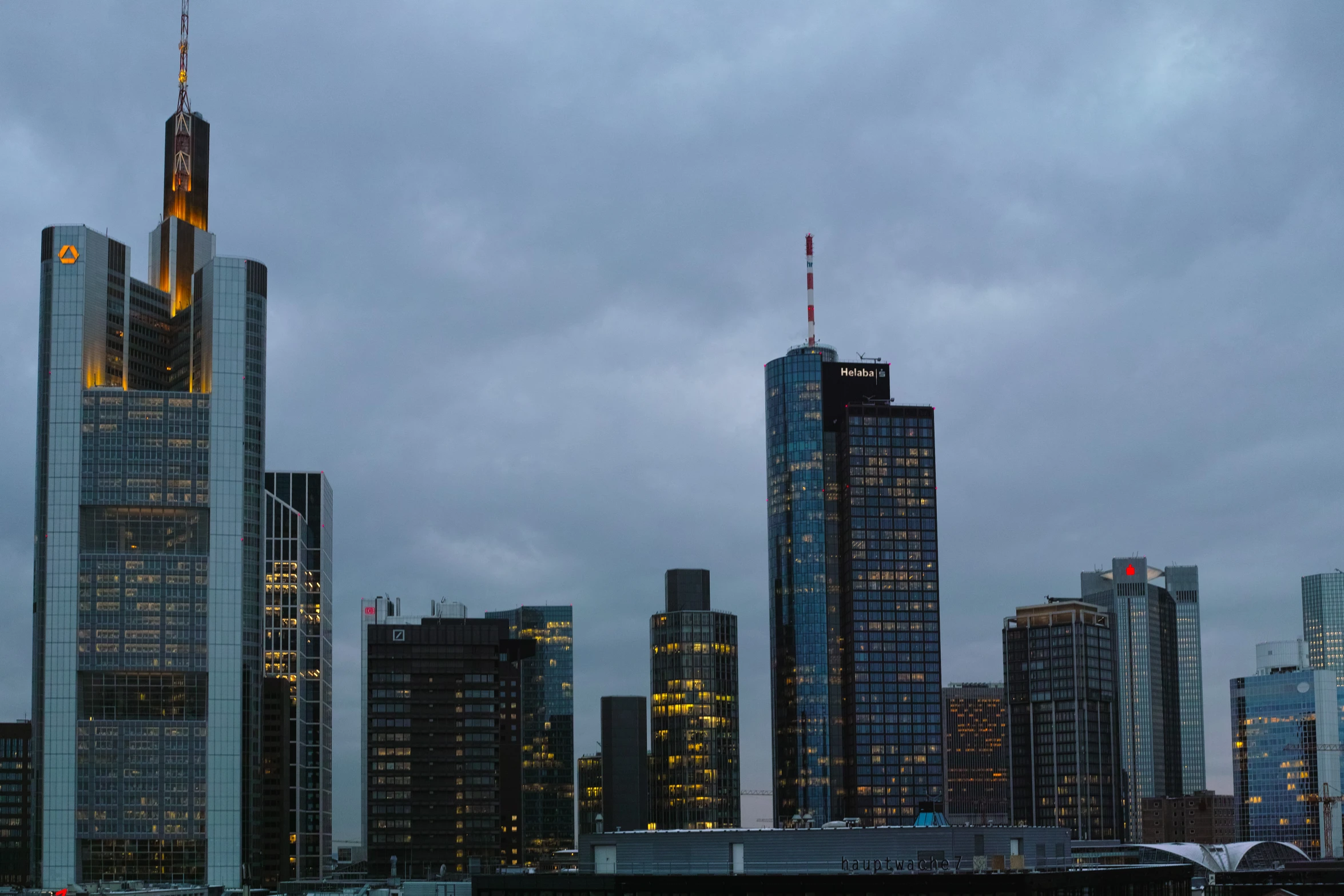 a tall city building towering over a large body of water