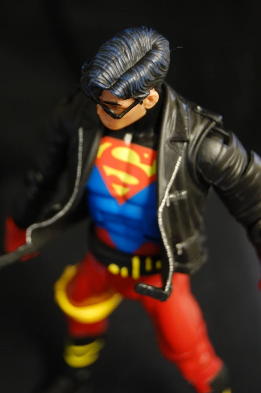 toy action figure wearing a black leather jacket and red pants
