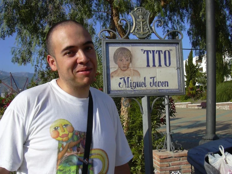 a man stands in front of a sign