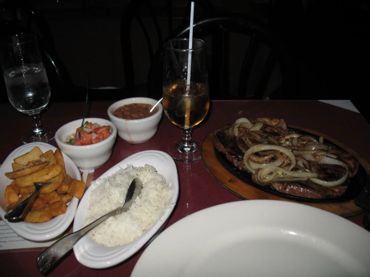 a table of food that includes fish and rice