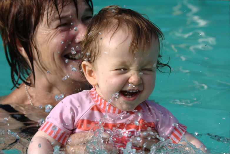 an image of woman and child swimming in pool