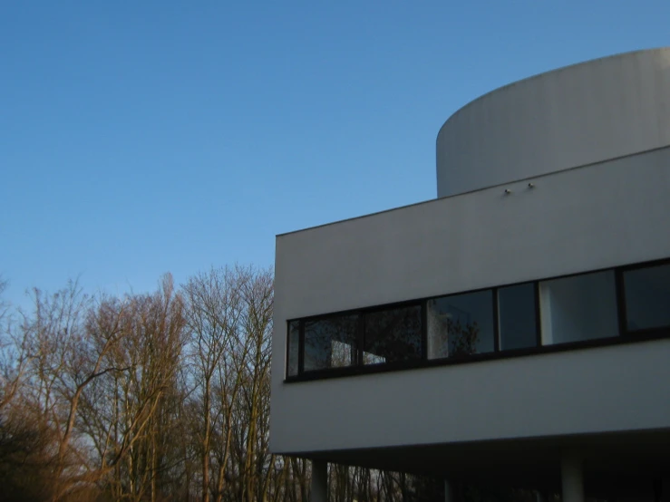 the building has several windows and a bird flying over it