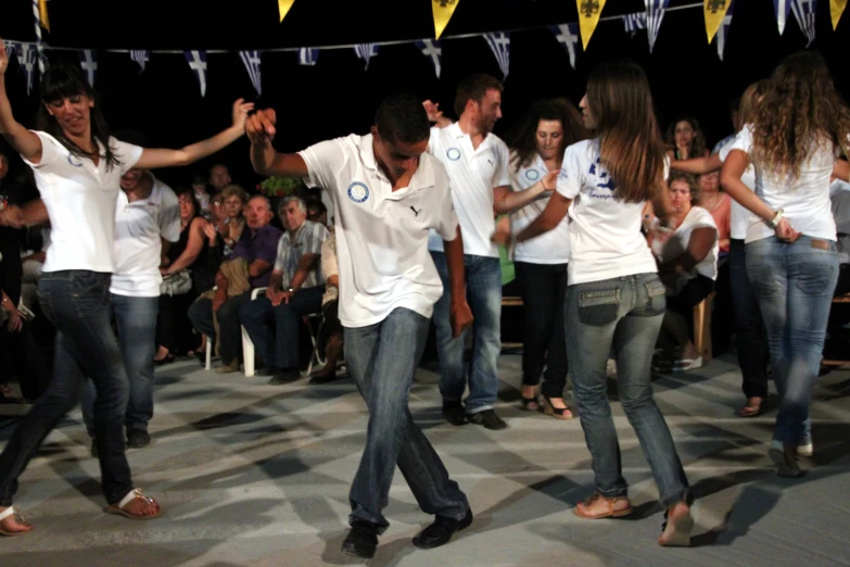 a group of people wearing white shirts and jeans