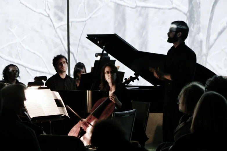 a person on stage playing music and people watching