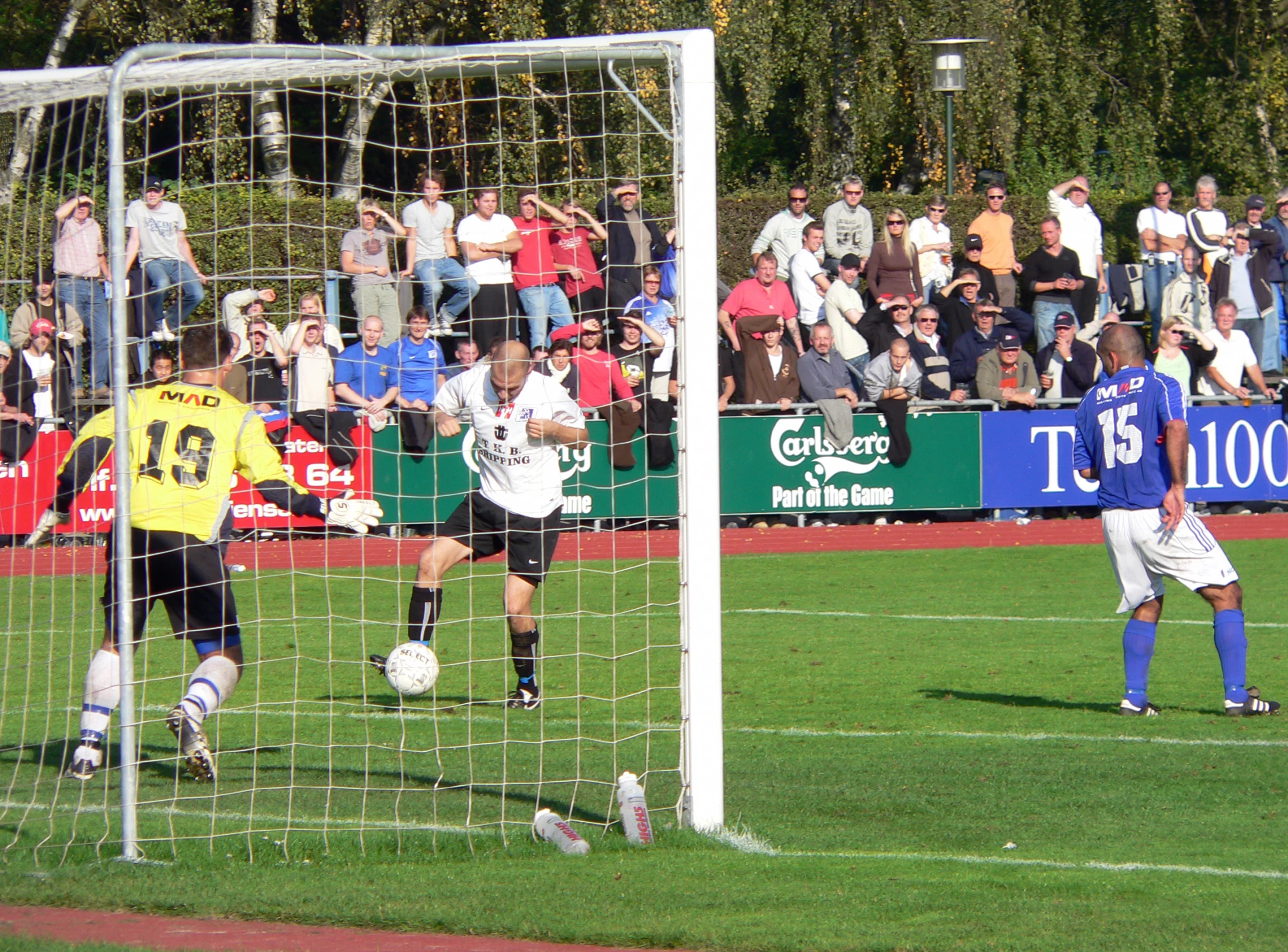 a group of people playing soccer at a field