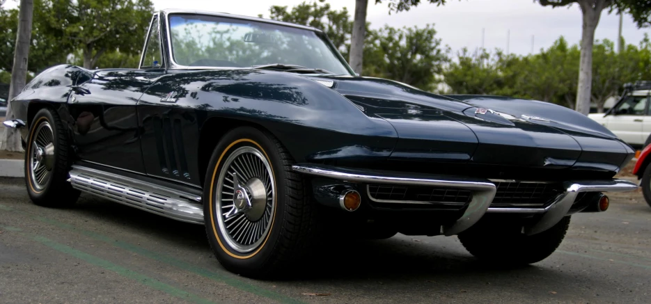 a classic corvette sits parked on a city street