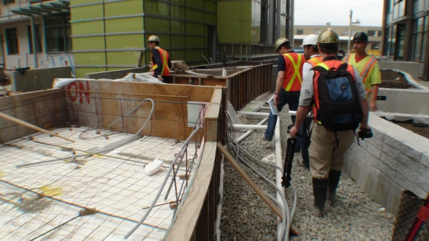 a group of construction workers moving down a building