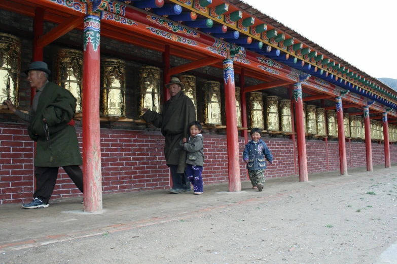 people are walking through the building with pillars