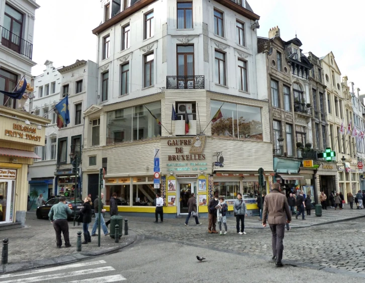 there are several people walking around a shopping area