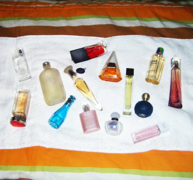 different bottles and cosmetics on a towel, arranged for use