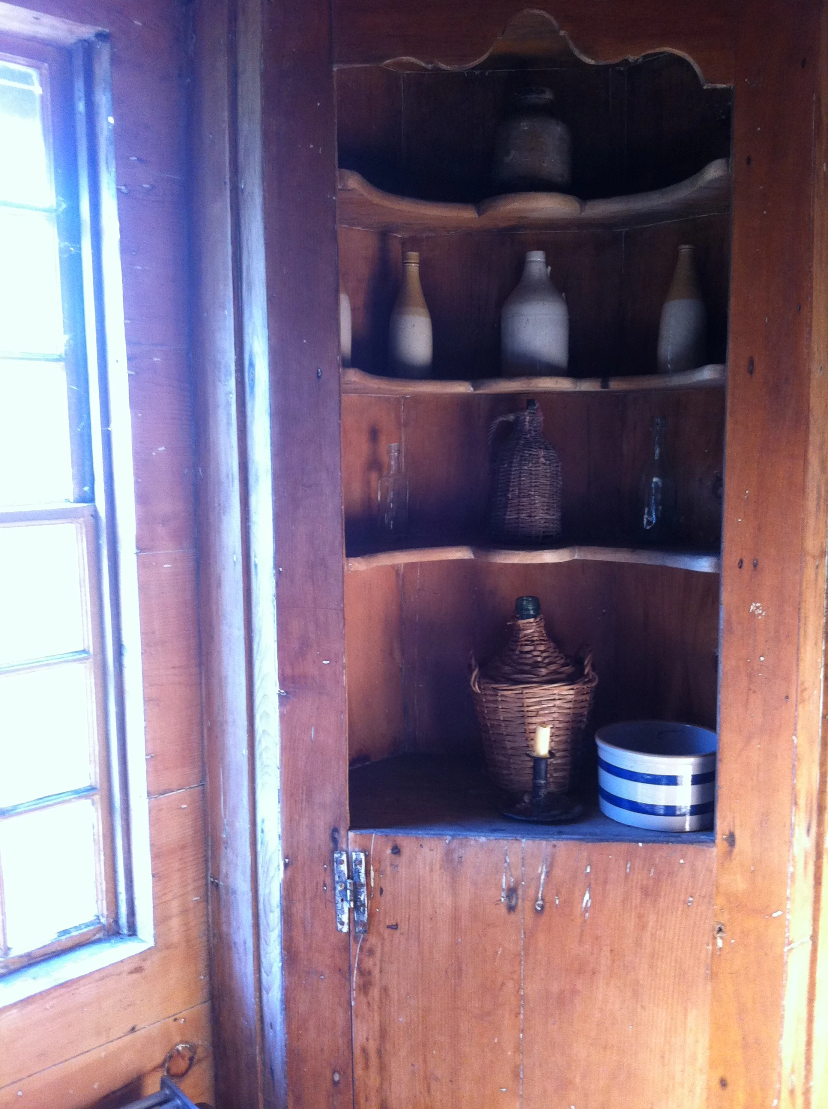 this is a wood hutch with some storage items inside