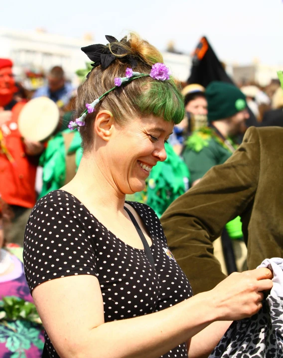 a woman smiles and looks at a cell phone