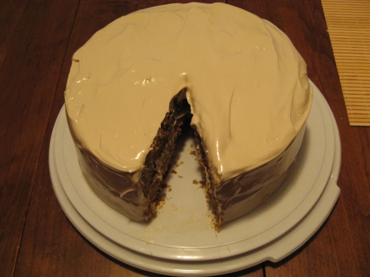 cake with one slice cut out of it on top of the table