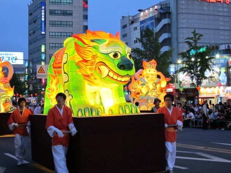 men walking down the street carrying lighted signs