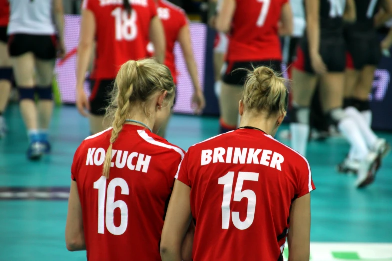 a pair of girls playing a game of volleyball