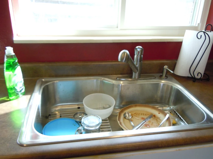 this is a kitchen sink with lots of clutter