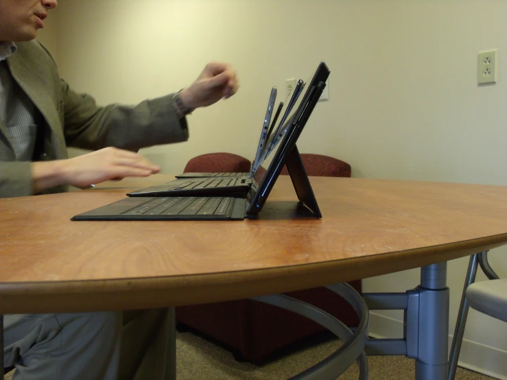 the man is playing the computer with his keyboard