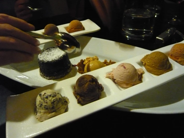 the four desert desserts on the dish include ice cream, chocolate cake and ding