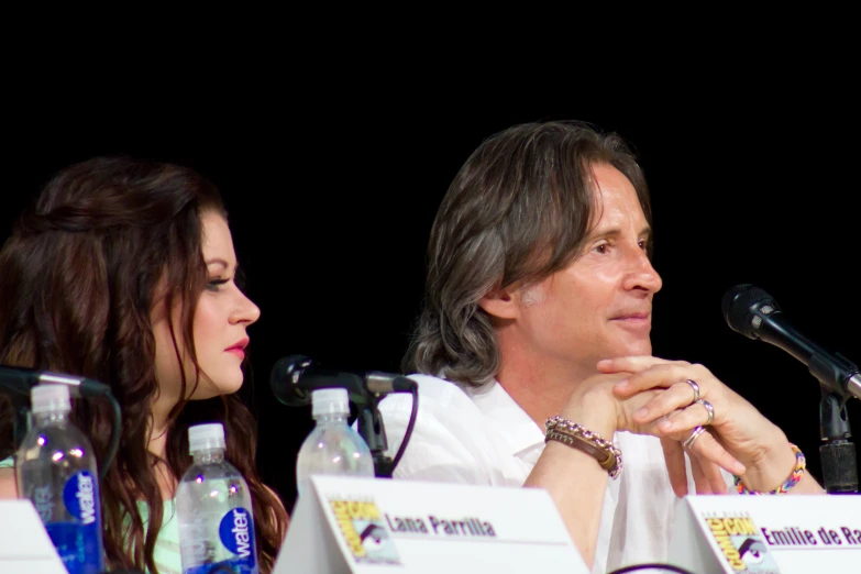 two people sitting at a table during a panel