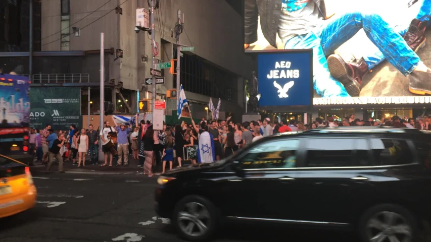 people are watching the movie at night in times square