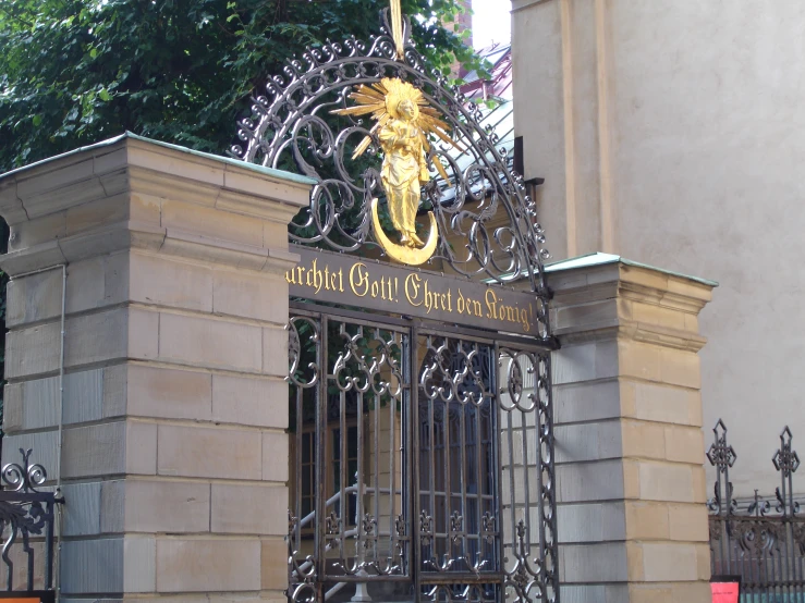 an iron gate with a fancy design on it