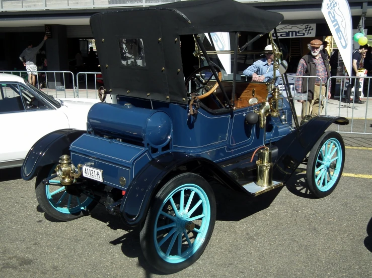 the old model car is painted with blue and white