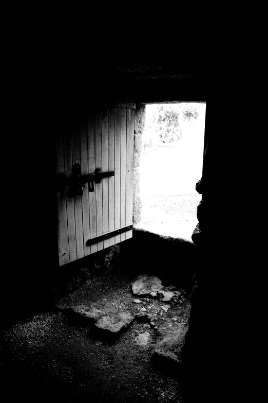 a dark bedroom with a toilet next to a window