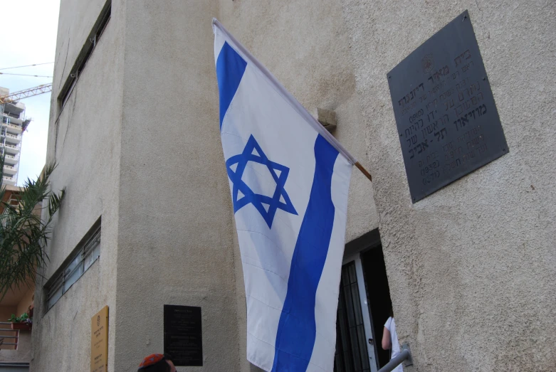 a jewish flag hanging outside of an old building