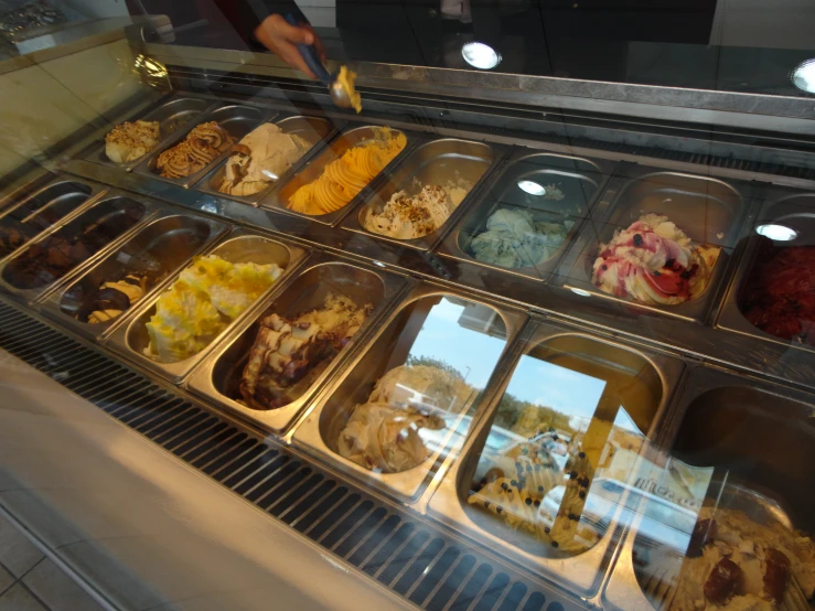 a deli has its trays full of various desserts