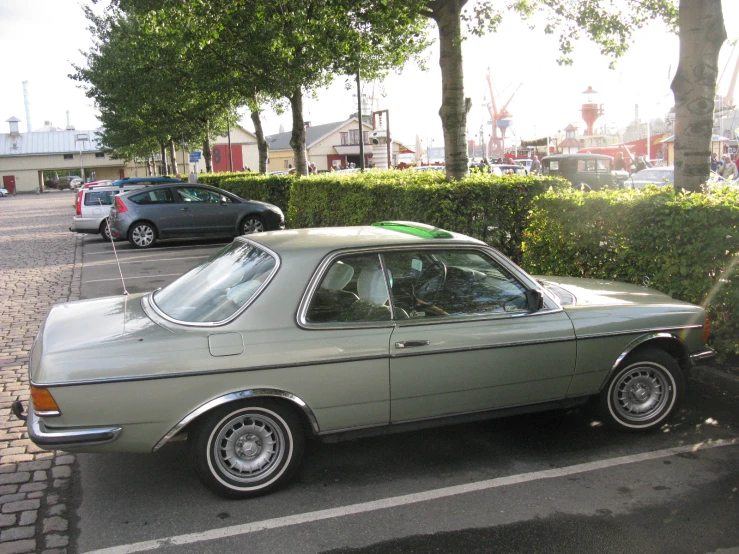 car parked in the lot on the side of a road