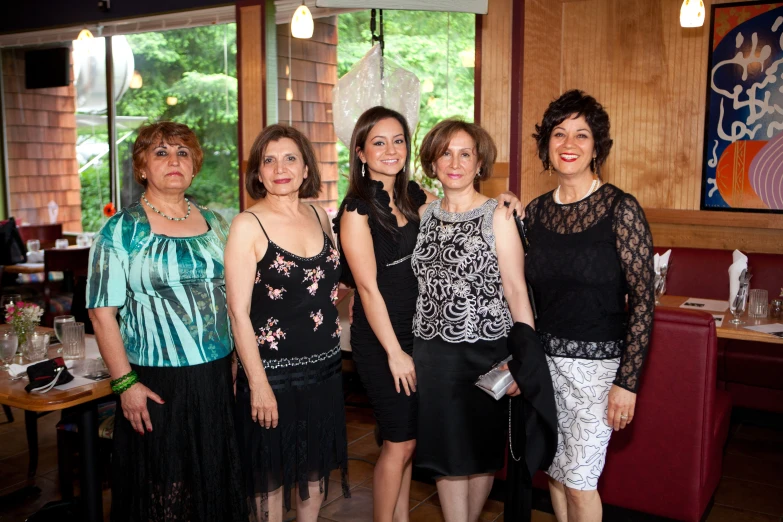 several women posing for a picture at a restaurant