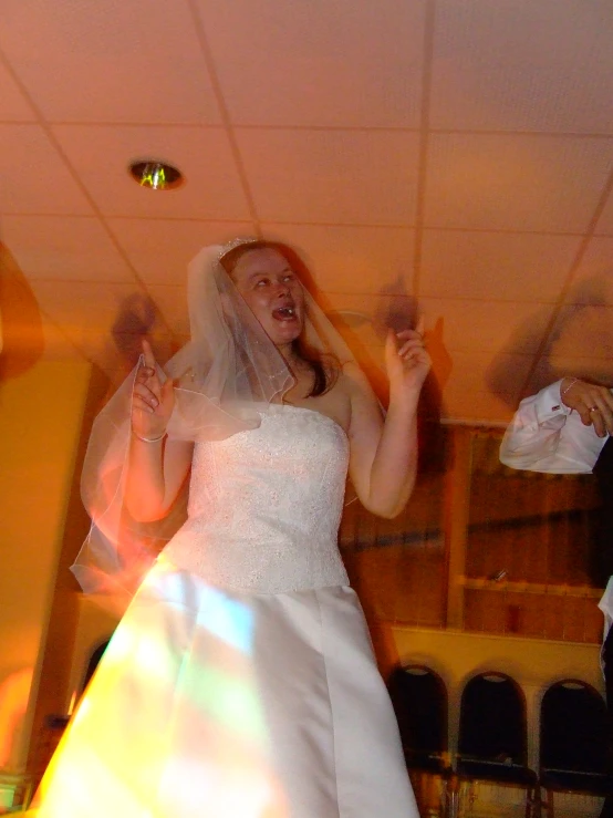 a bride is dancing in her wedding dress