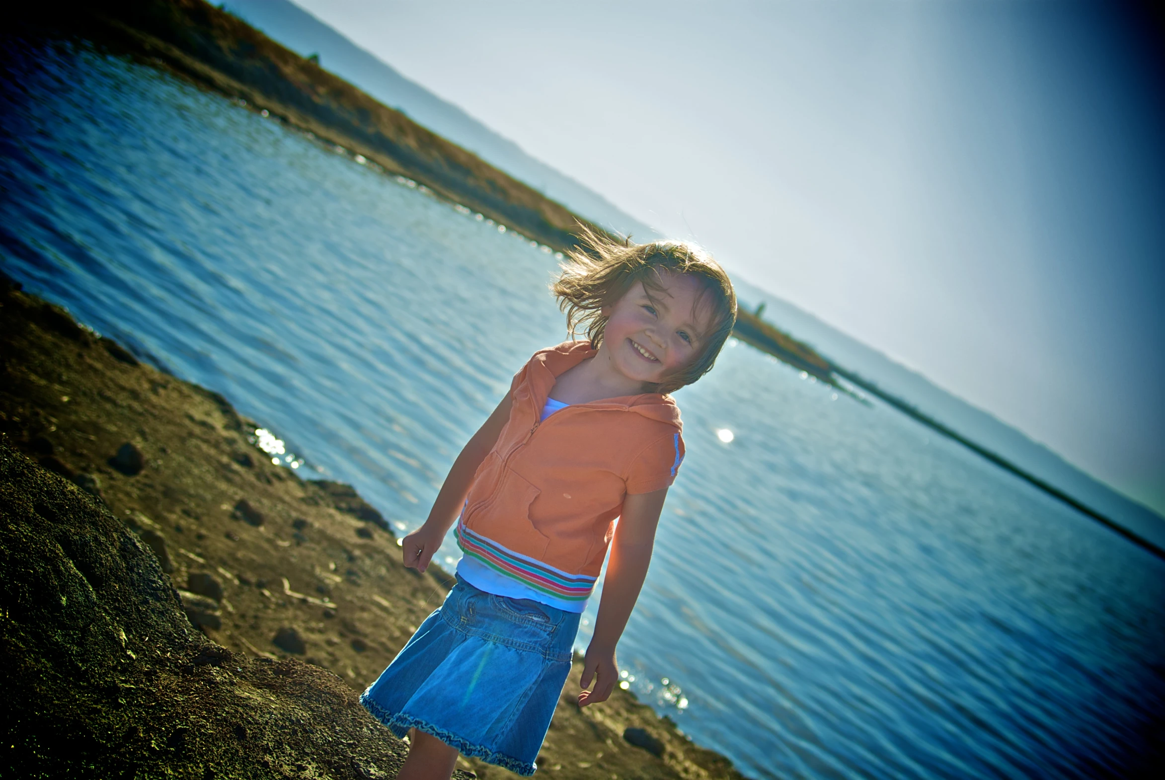 a small child is walking by some water