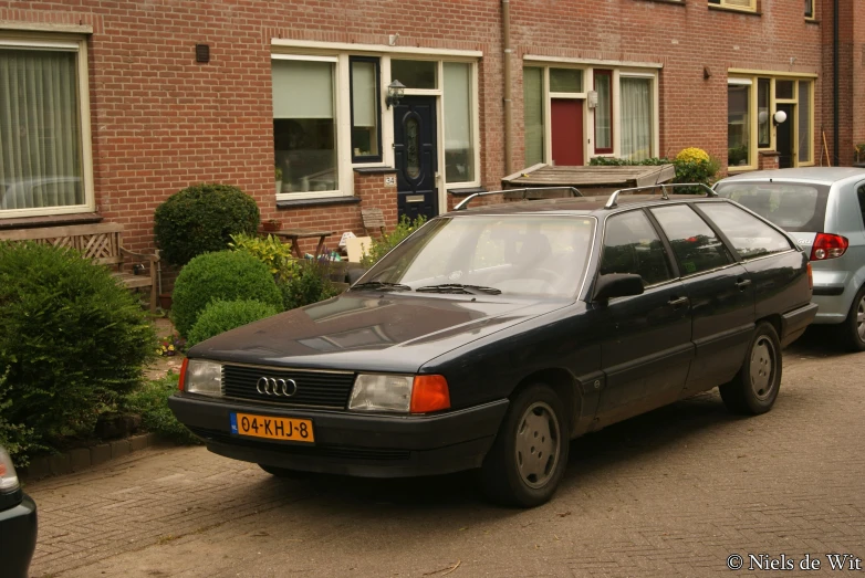 a couple of cars parked in front of brick building