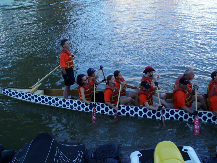 a rowboat full of people paddles through the water