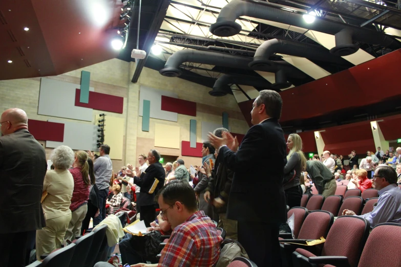 a large crowd of people waiting for their next lecture