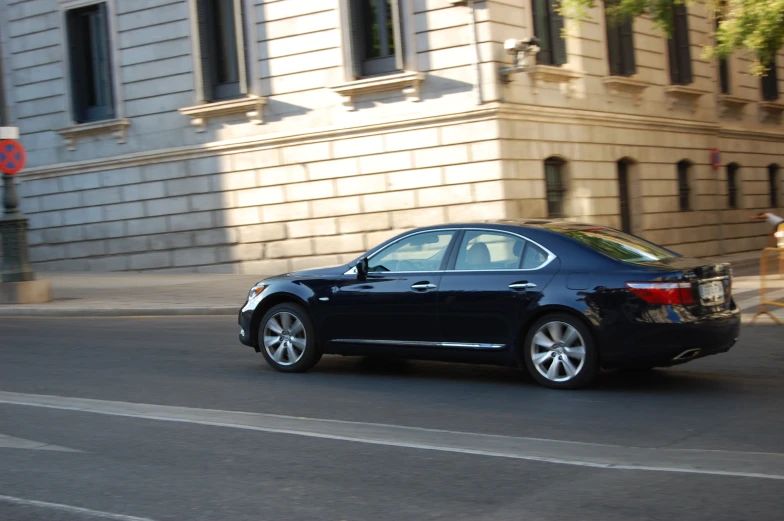 a parked car on the street next to some building