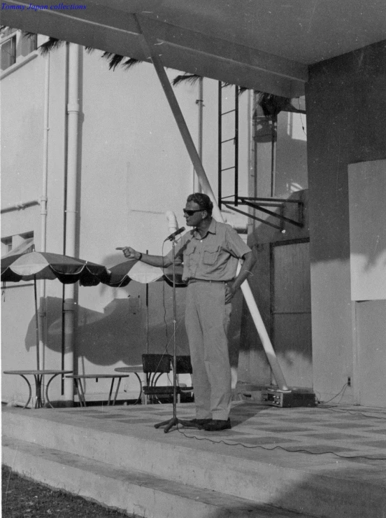 a man is standing next to the microphone outside