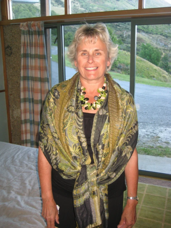 a woman standing on top of a bed wearing a scarf